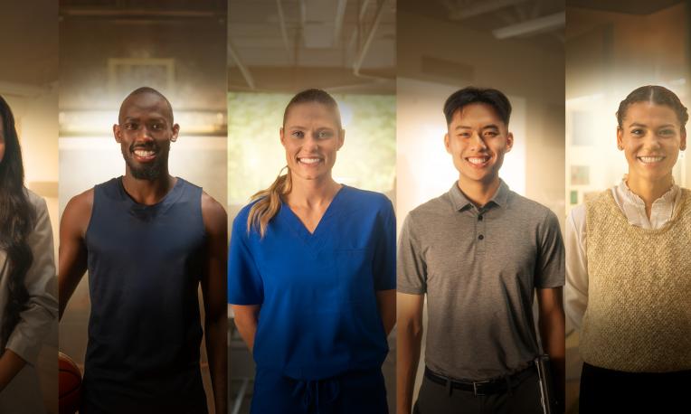 Five people standing together, smiling, diverse professions shown.