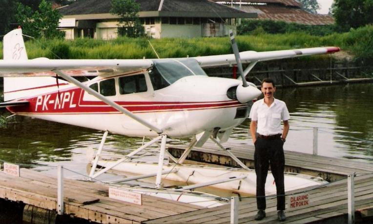Man stands in front of plane