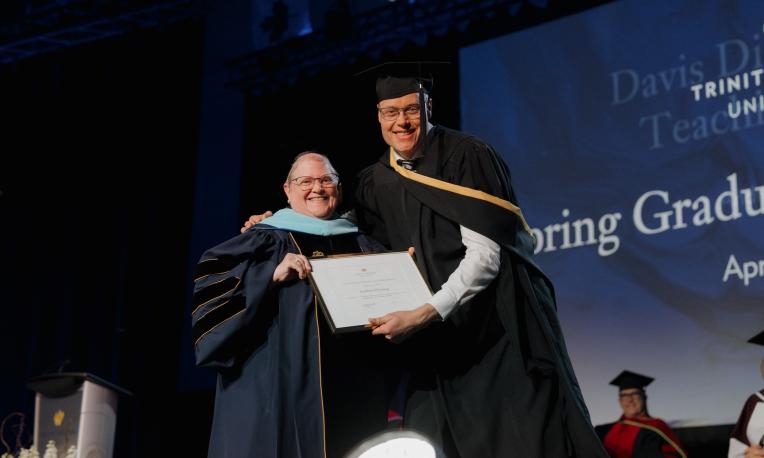 Andrew Heming receiving a teaching award presented by Laurie Matthias