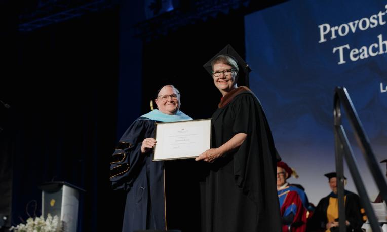 Loranne Brown receiving a teaching award presented by Laurie Matthias