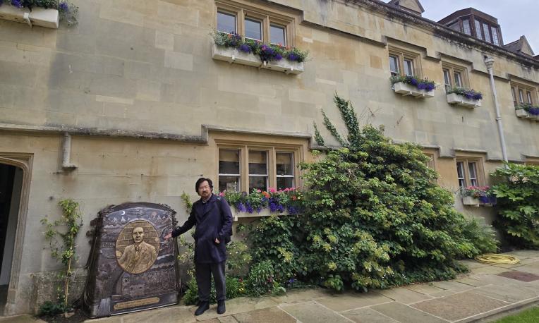 Man beside Oxford memorial of famous author
