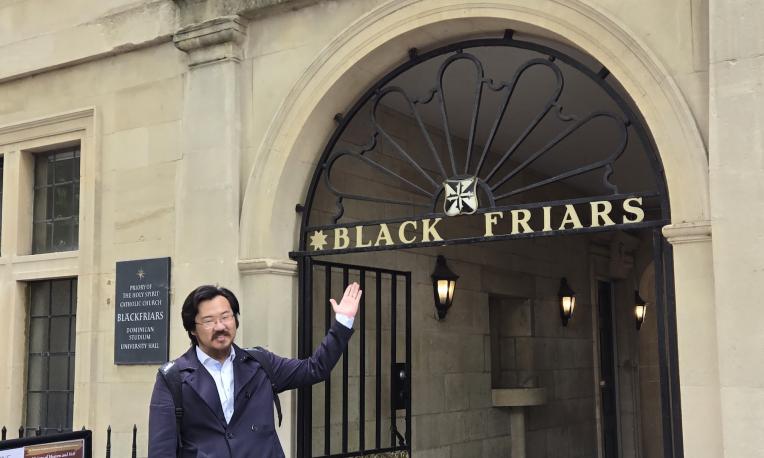 Man beside Oxford college building