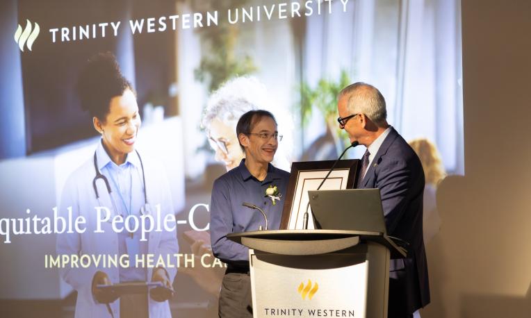 Todd Martin presenting certificate to Richard Sawatzky in DeVries Centre