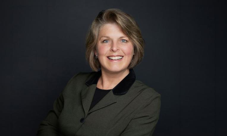 Headshot of Dr. Rosemary Flaaten in front of a black background