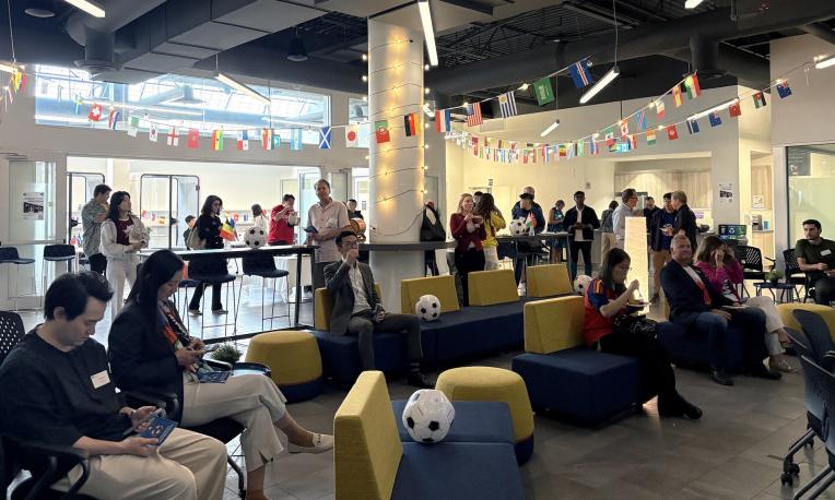 group of people in the Richmond campus with World Cup decorations around the room.