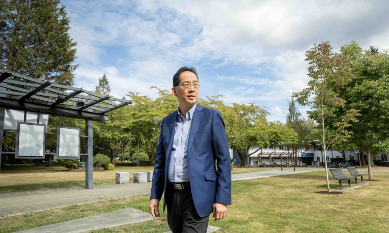Dr. David Pao standing outdoors on the Trinity Western University campus.
