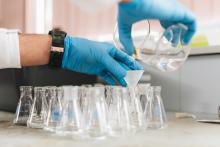 hands working with beakers