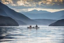 people canoeing on blue water