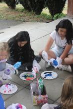 kids sitting on the ground working on art projects