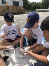 Kids playing with bowl of clay