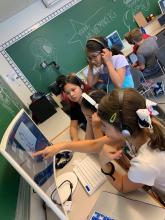 kids wearing headphones and editing a video together