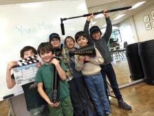 kids holding film equipment and smiling