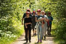 people wearing safety gear walking together in the woods