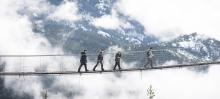 people crossing a bridge 