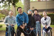 people doing a high ropes course together