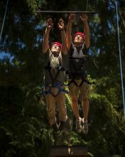 two people doing a high ropes course together