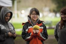 people holding small dolls and talking