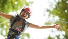 girl enjoying a high ropes course