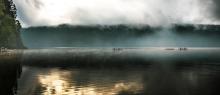 beautiful view of a foggy lake from a distance 