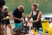 people cooking together outdoors