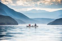 two people on boats on a lake