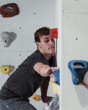 Man climbing a bouldering wall.
