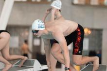 Man in swimming gear about to launch.
