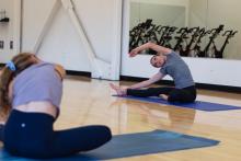 women in a fitness class stretching