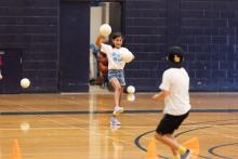 A girl throwing a dodgeball