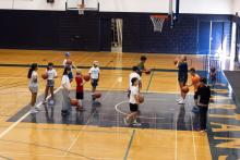 A group of kids lining up for dodgeball
