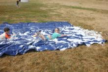 Kids playing on a slip-n-slide.