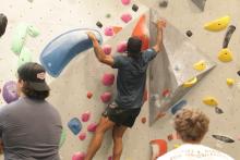 person climbing the bouldering wall
