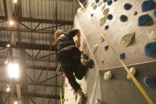 person climbing the bouldering wall