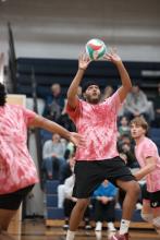 People playing volleyball in the gym