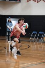 People playing volleyball in the gym