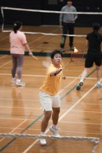 People playing badminton in the gym