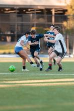 People playing soccer outside