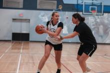 people playing basketball in a gym