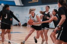 people playing basketball in a gym