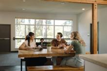 Students gathered around a dining table in Robson Hall.