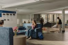 Students relaxing in a spacious residence common lounge.