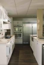 Robson Hall kitchen with white cabinetry and stainless-steel appliances.