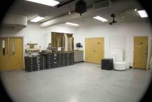 Art studio with flat-file storage drawers, drawing boards, and display plinths.