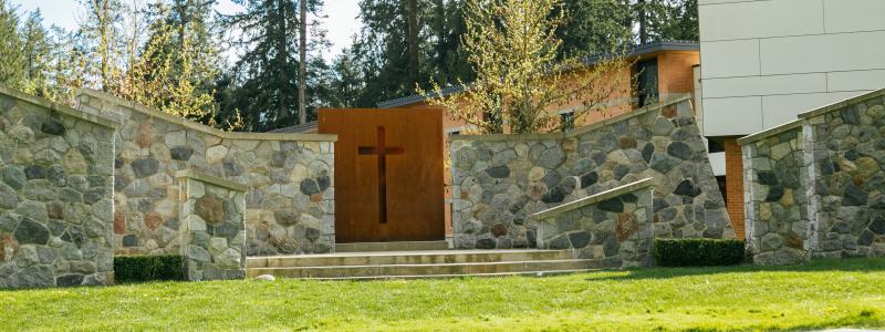 The outdoor chapel on TWU Langley campus. It is sunny. There is green grass.