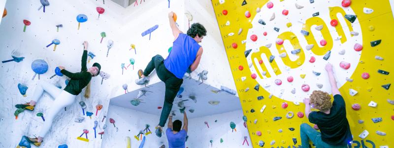 Students on indoor rock climbing (bouldering moon) wall in the TWU Langley gym.