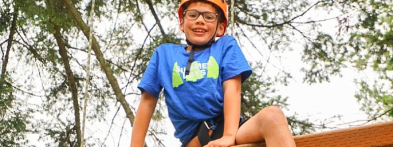 Young boy on the TWU Langley ropes course.