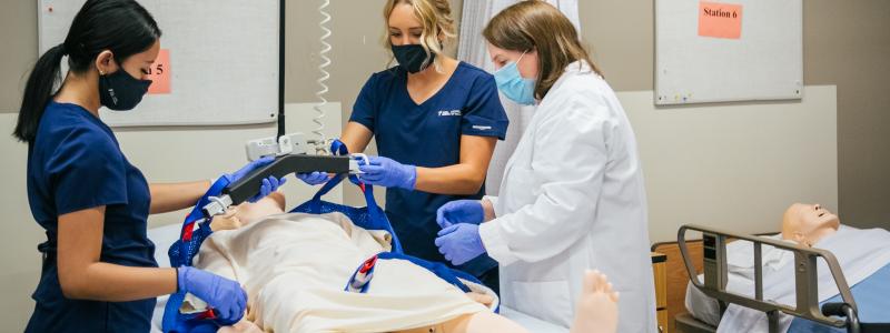 Nursing students learning from professor