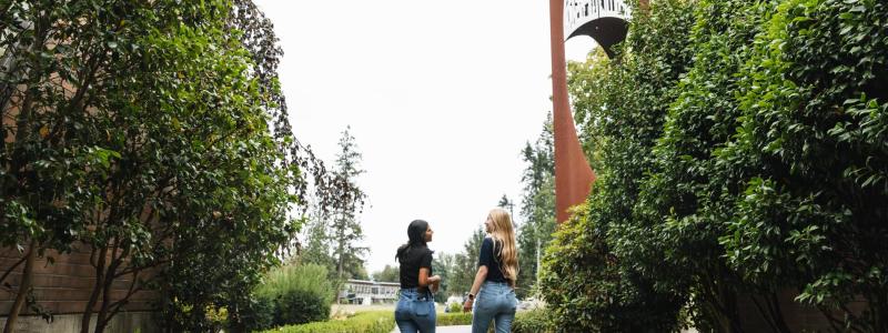 students walking by bell tower