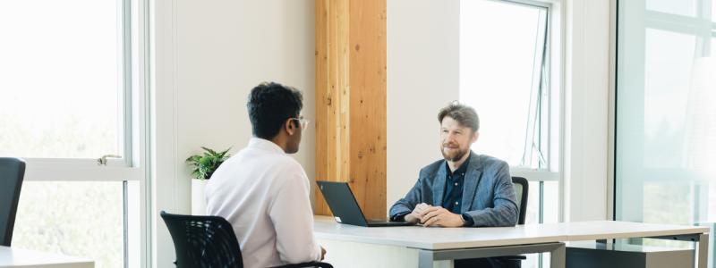 student meeting with staff member