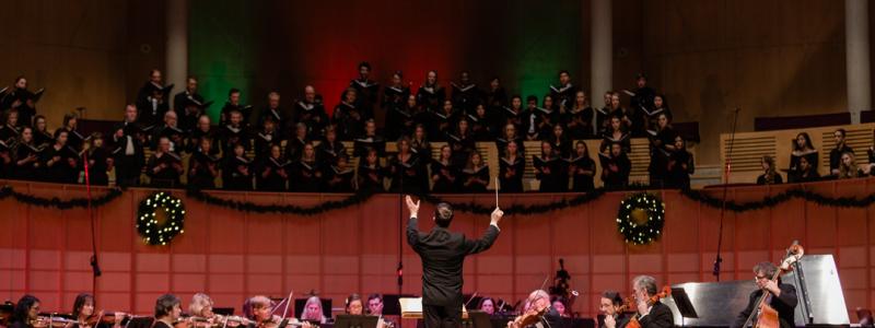 conductor leading orchestra and choir